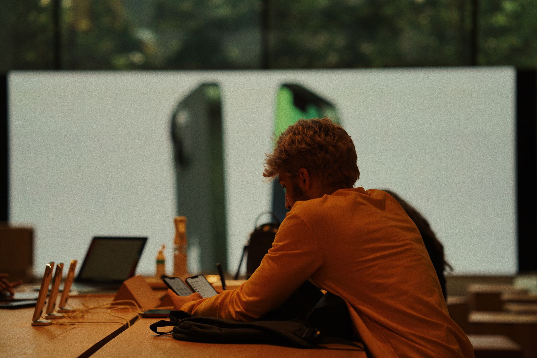 iPhone screen showing iOS interface on a modern workspace