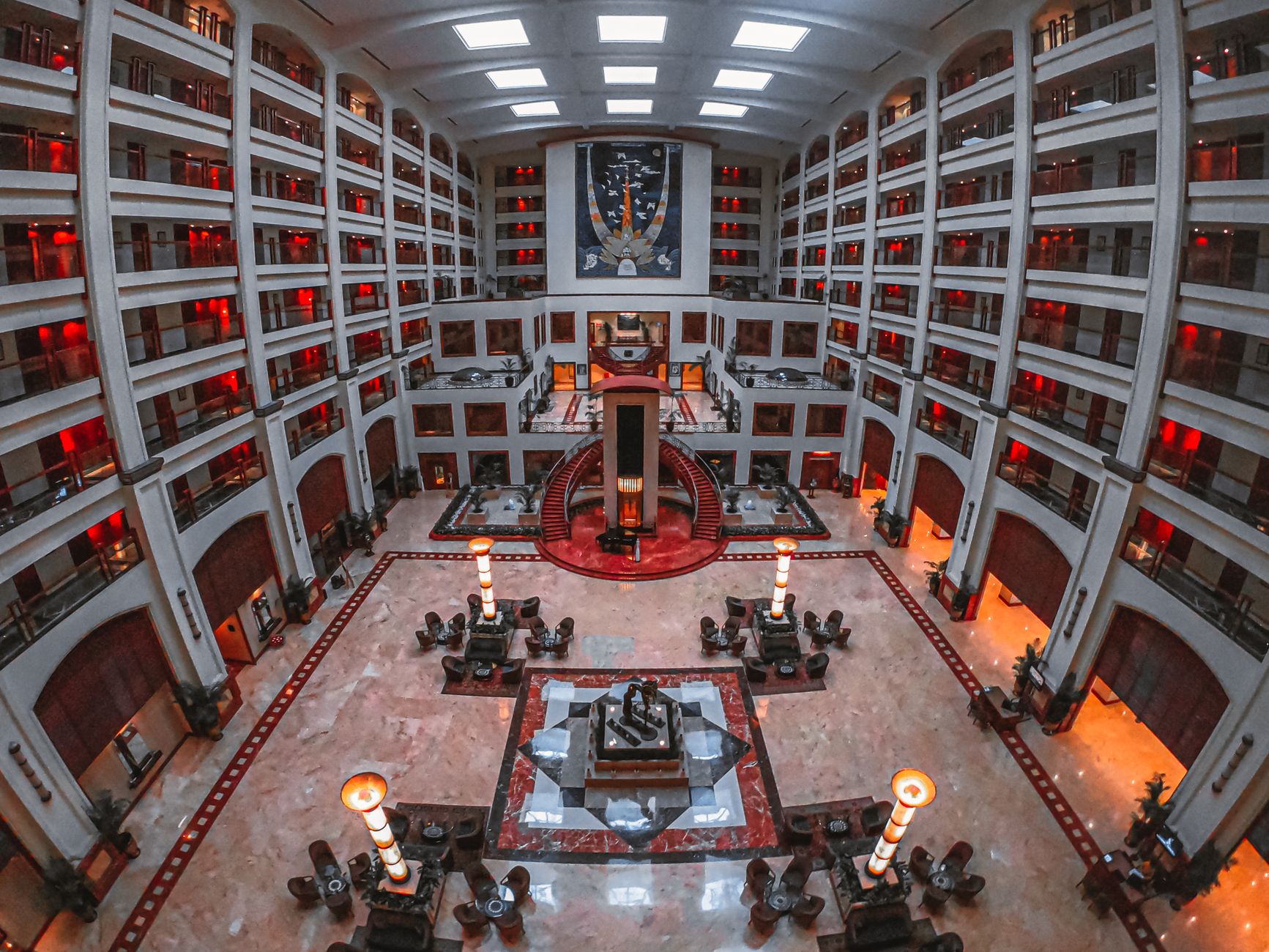 Luxury hotel concierge at desk with digital tablet and elegant lobby