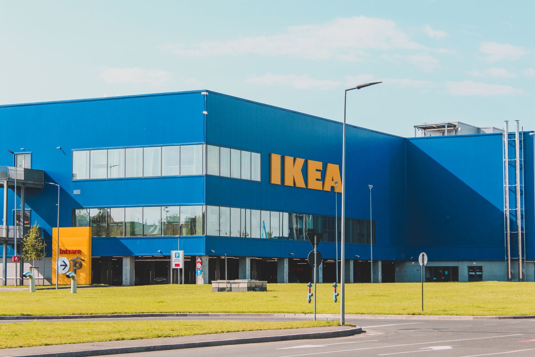 IKEA store facade with blue and yellow branding and large parking area