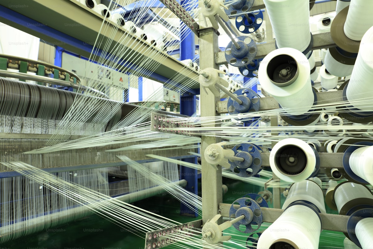 Japanese artisan workshop with close-up on precision tools and fine textile materials